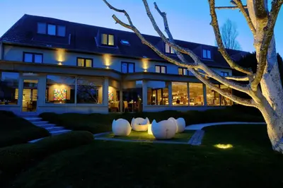 a house with white spheres in front of it at Le Côté Vert in Waterloo