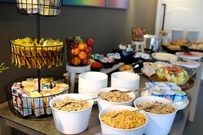 a buffet with bowls of food on a table at Le Côté Vert in Waterloo