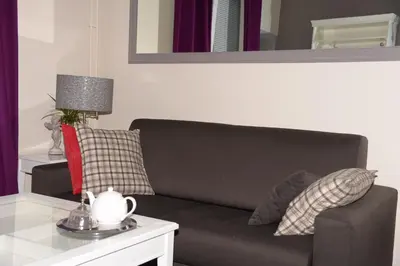 a living room with a couch and a table at Appartbrussels in Brussels