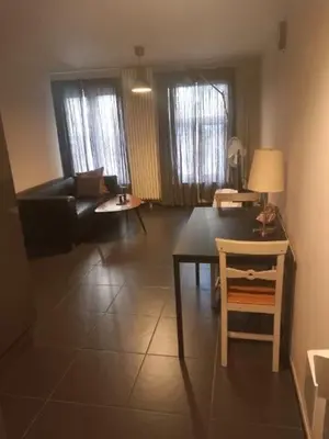 a living room with a couch and a table at Appartbrussels in Brussels