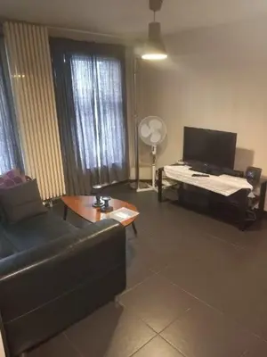 a living room with a couch and a table at Appartbrussels in Brussels