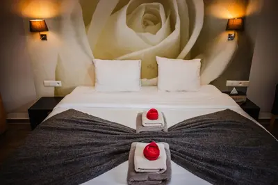 a hotel room with a bed with towels on it at Boutique hotel Roosendaelhof in Geel