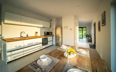 a kitchen with a wooden table and a sink at VELPE 55 in Bierbeek