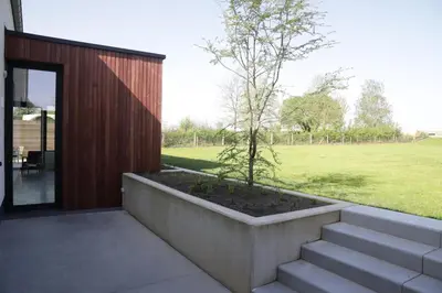 a small tree in a planter next to a house at ma-tinée in Beauvechain