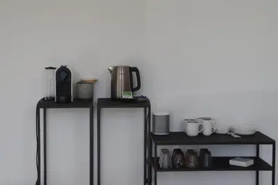 two refridgerators with cups and mugs on a shelf at ma-tinée in Beauvechain