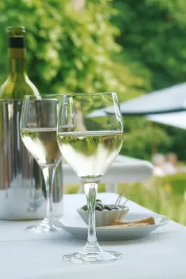 two glasses of white wine sitting on a table at Hotel Geerts in Westerlo