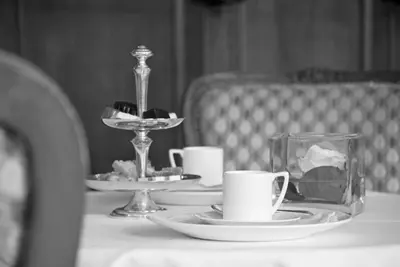 a table with two plates and cups on a table at Hotel Geerts in Westerlo
