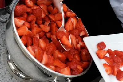 a bowl of strawberries with a spoon in it at Hotel Geerts in Westerlo