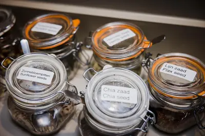 three jars of food on a shelf with labels at Hotel Geerts in Westerlo