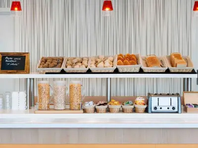 a display case with different types of bread and pastries at ibis Budget Brussels South Ruisbroek in Ruisbroek