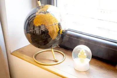 a glass globe on a shelf next to a window at Quartier Leonard in Ghent