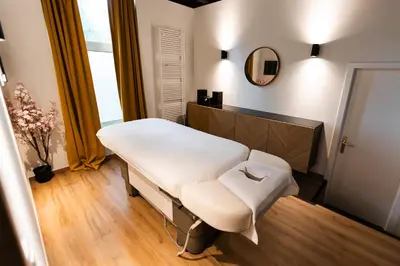 a hospital room with a bed and a mirror at Hotel Orion in Ghent