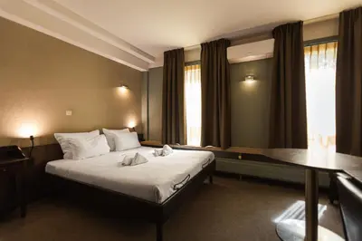 a hotel room with a bed and a table at Hotel Orion in Ghent