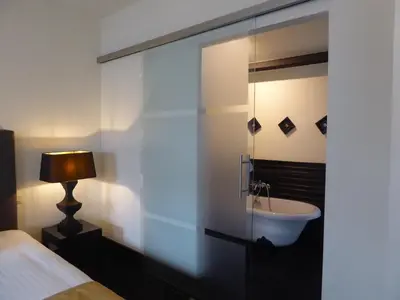 a bedroom with a sink in a glass wall at B in Antwerp in Antwerp