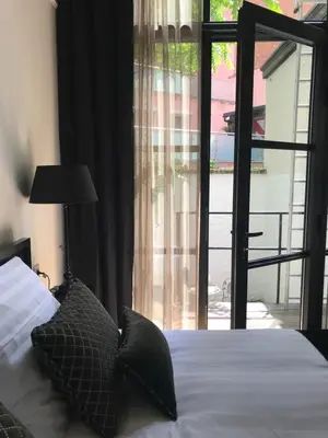 a bedroom with a bed and a large window at B in Antwerp in Antwerp