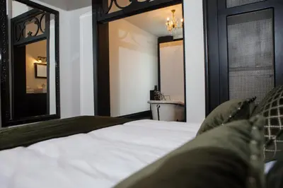 a bedroom with a bed and two mirrors at B in Antwerp in Antwerp