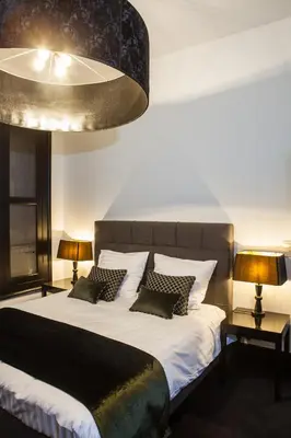 a bedroom with a large bed with pillows and two lamps at B in Antwerp in Antwerp