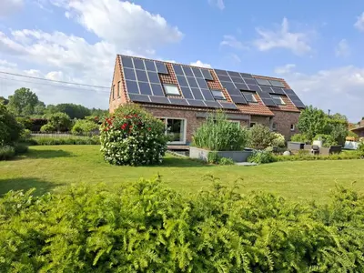 a house with solar panels on the roof at B&B Welcome Home in Laakdal