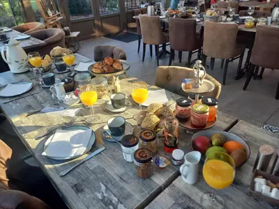 a table with breakfast foods and drinks on it at B&B Welcome Home in Laakdal