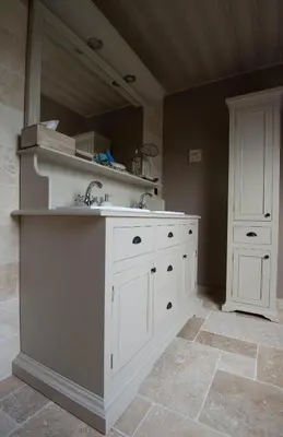 a bathroom with white cabinets and a sink at B&B Welcome Home in Laakdal