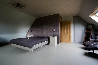 a bedroom with a bed and a table and a chair at B&B Welcome Home in Laakdal