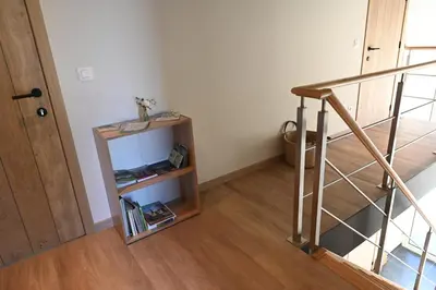 a staircase with a book shelf next to a door at B&B Dujardin in Dilbeek