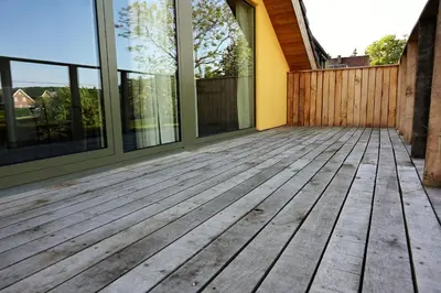 an empty porch of a house with glass windows at B&B Dujardin in Dilbeek