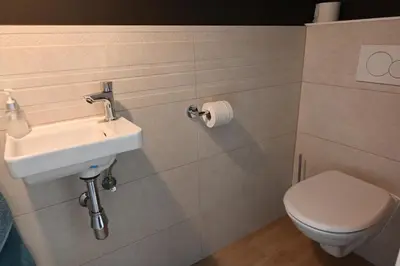 a bathroom with a sink and a toilet at B&B Dujardin in Dilbeek