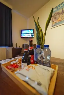 a table with bottles of alcohol on top of it at Arku apartments Brussels Airport in Zaventem
