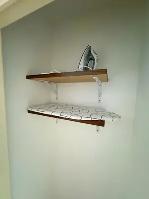 a shelf in a room with a white wall at Arku apartments Brussels Airport in Zaventem