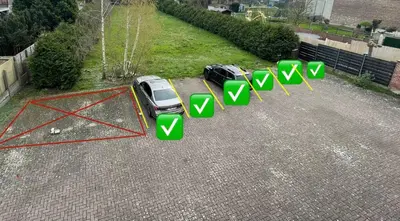 a car parked in a parking lot with green arrows at Arku apartments Brussels Airport in Zaventem