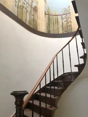 a staircase with a painting on the wall at Bed & Boon in Ghent