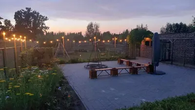a park with a playground at night with lights at Vakantiewoning De Schuur Tienen in Tienen