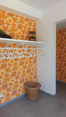 a room with shelves and a basket on a wall at Vakantiewoning De Schuur Tienen in Tienen
