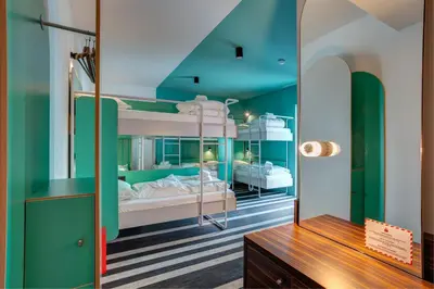 a room with two bunk beds and a mirror at MEININGER Hotel Bruxelles Gare du Midi in Brussels