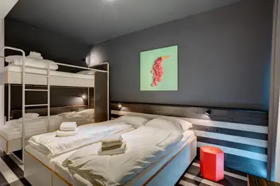 a bedroom with two bunk beds in a room at MEININGER Hotel Bruxelles Gare du Midi in Brussels