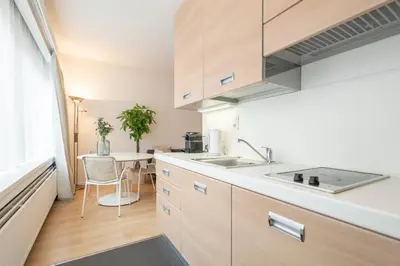 a kitchen with a sink and a table at Theaterstudio 1 Antwerp in Antwerp
