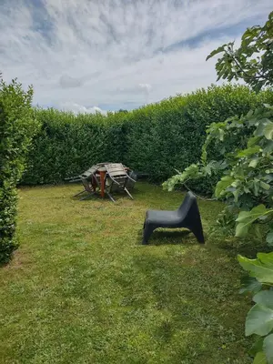 a picnic table and a bench in the grass at Land Scape guesthouse in Eeklo