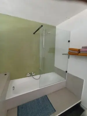 a bathroom with a shower with a glass door at Land Scape guesthouse in Eeklo
