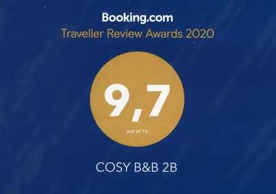 a sign that reads traveler review awards with a gold circle at COSY B&B 2B in Overijse