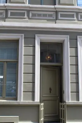 a white building with a door and two windows at Holiday Home Jules in Antwerp