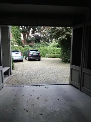 a garage door with cars parked in a parking lot at Holiday Home Jules in Antwerp