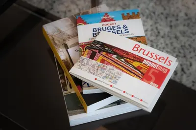 a pile of books sitting on top of a table at Royal Arts-Loi Studio in Brussels