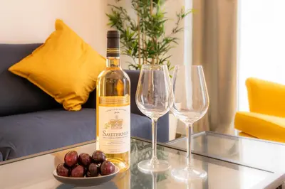a bottle of wine sitting on a table with two wine glasses at Royal Arts-Loi Studio in Brussels
