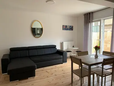 a living room with a black couch and a table at Attractive modern apartment in Brussels