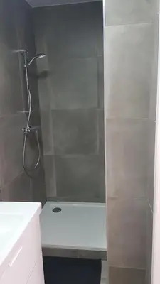 a bathroom with a shower with a white bath tub at Attractive modern apartment in Brussels