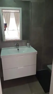 a bathroom with a white sink and a mirror at Attractive modern apartment in Brussels