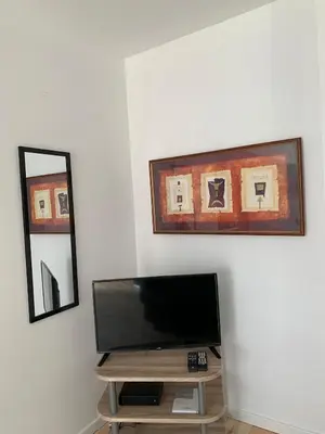 a flat screen tv sitting on a table in a room at Attractive modern apartment in Brussels