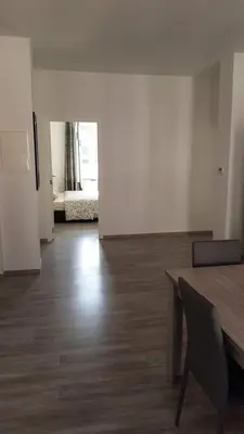 a room with a table and a room with a bedroom at Modern Apartment Second Floor in Brussels