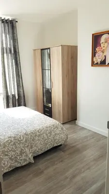 a bedroom with a bed and a wooden floor at Modern Apartment Second Floor in Brussels